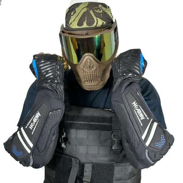 Person wearing paintball gear and elbow pads.