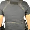 Person wearing a black tactical vest.