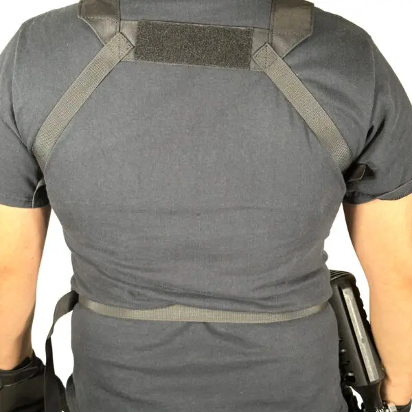 Person wearing a black tactical vest.