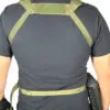 Person wearing a green tactical harness.
