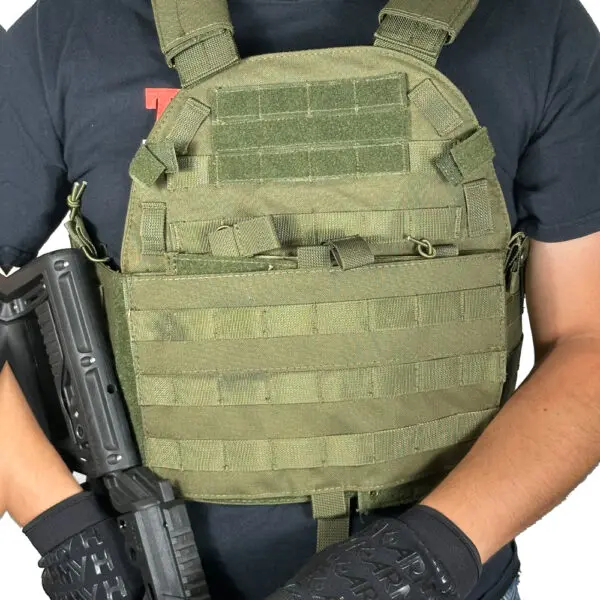 Person wearing a green tactical vest.